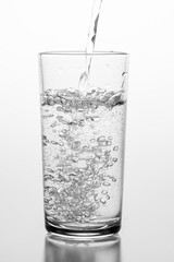 Pouring sparkling water into a glass. A container for storing liquids.