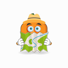 The Pumpkin mascot character holds a map. vector illustration