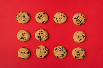 Obraz premium Sweet chocolate cookies concept. Top flatlay close up view photo of set of biscuits with one empty space isolated over light color background
