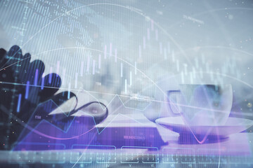 Double exposure of financial chart drawing and desktop with coffee and items on table background. Concept of forex market trading