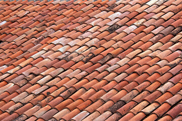 Vintage clay tiled roof. Multi colored old roof tiles background.