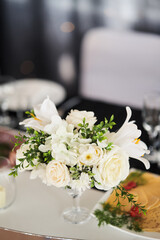 Decoration of wedding tables. Plates with the numbers of the tables at the wedding. Flower arrangements