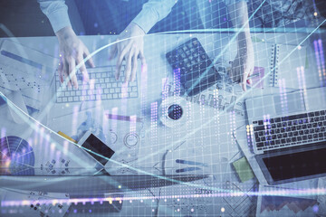 Double exposure of man and woman working together and financial chart hologram drawing. market analysis concept. Computer background. Top View.
