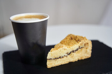 Cake with coffee on a black tray.