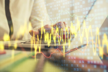 Double exposure of businesswoman hands typing on computer and financial graph hologram drawing. Stock market analysis concept.