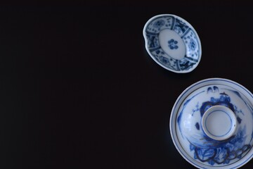 picture rice bowl. with picture small plate.This is a very fine example of Japanese traditional antique “ imari ware ”. black background soft focus image.