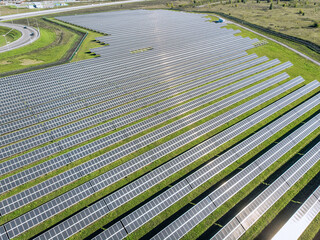 Solar Photovoltaic of aerial view, solar plant rows array of on the grass on the farm. Top view