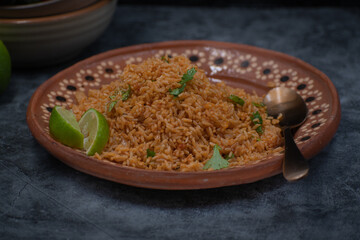 Authentic Mexican rice served in traditional clay plate, copy space