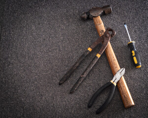 hand tools with rustic background. hammer, pliers, screwdriver.

