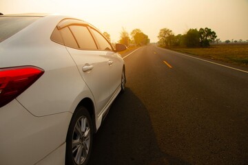 Fototapeta na wymiar Car on road with sunset