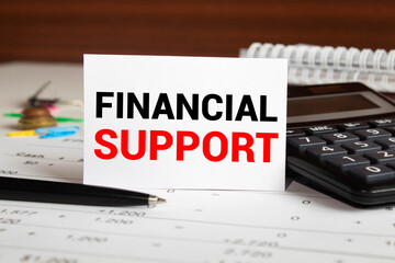Financial Support text written on a notebook with pencils