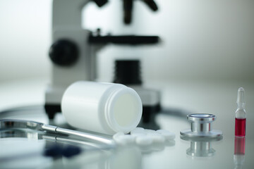 Stethoscope ampoule pill microscope on glass table