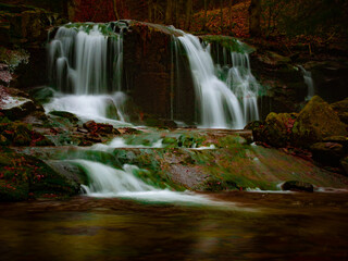 Obraz premium Wild brook with stones and waterfall in Jeseniky mountains, Eastern Europe, Moravia. Clean fresh cold watter, water stream. Long exposure image. .