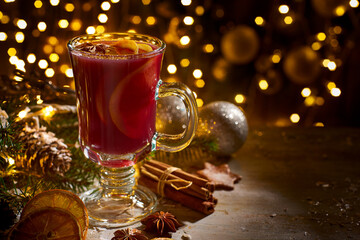 Glass cup of mulled wine on christmas decorations