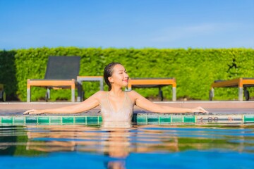 Portrait beautiful young asian woman relax smile leisure around outdoor swimming pool