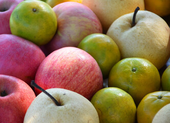 Red apple with orange fruits. Different colorful of fresh fruits.
