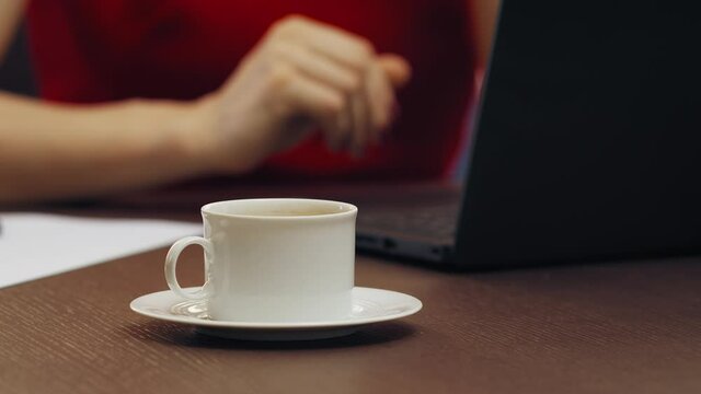 Stressed Business Woman Working Late At Night In The Office, She Had Too Many Cups Of Coffee And Feels Exhausted