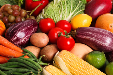 Assortment of fresh organic fruits and vegetables as background, above view