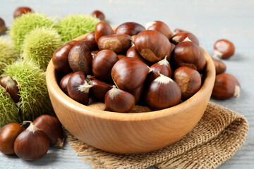 Fresh sweet edible chestnuts in bowl on table