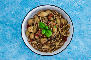 plant-based food, vegan mushroom sauce pasta with butter beans and chopped tomatoes