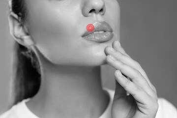 Woman with herpes on lip, closeup. Black and white effect