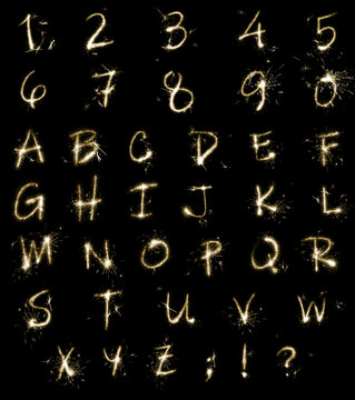 Set with letters and numbers made of sparkler on black background
