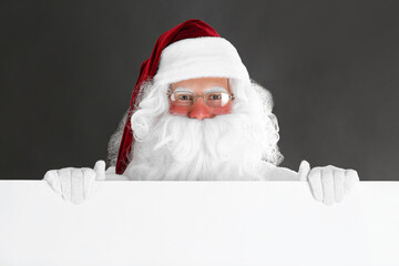Santa Claus holding empty banner on black background