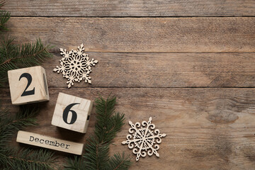 Flat lay composition with block calendar on wooden background, space for text. Boxing day concept