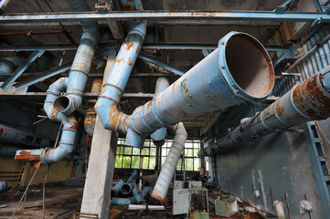 Old rusty pipeline in abandoned plant Jupiter in Chernobyl zone