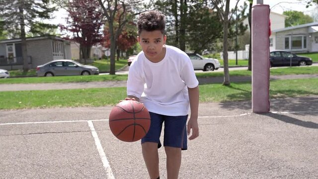 cute Afro american players playing basketball outdoors