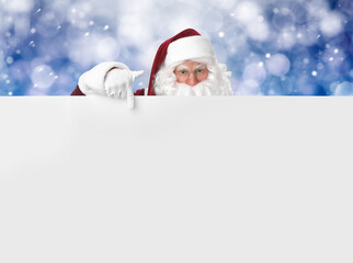 Santa Claus with blank banner on blurred blue background. Space for design