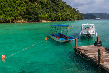 Fototapeta na wymiar Boats at a pier at Gaya Island in Tunku Abdul Rahman National Park, Sabah, Malaysia