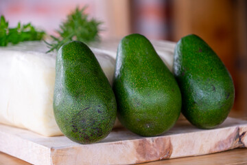 Large fresh cheese with avocados