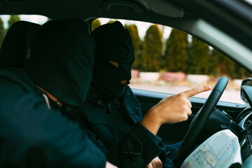 bank robbers putting their mask on prepared to do their next robbery,checking and loading their...