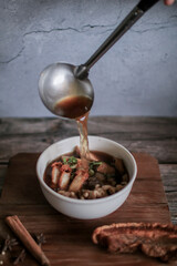 Chinese roll noodles soup with crispy pork and egg , noodle. Thai language called 