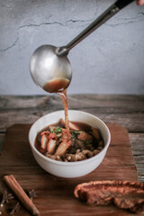 Chinese roll noodles soup with crispy pork and egg , noodle. Thai language called 