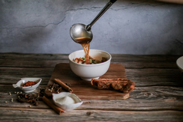Chinese roll noodles soup with crispy pork and egg , noodle. Thai language called 