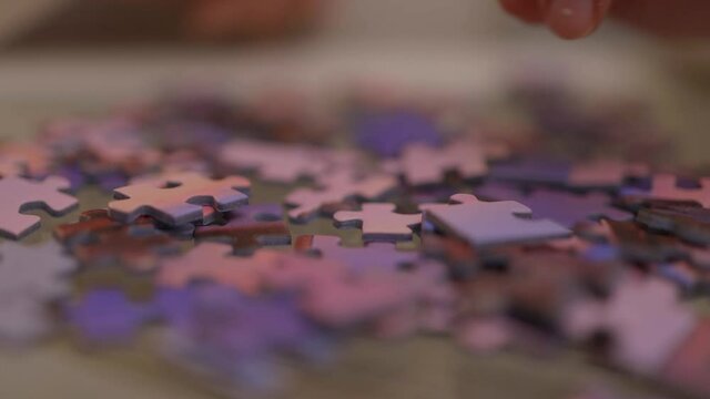 Young woman spends time with puzzles - videoclip