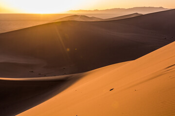 Fototapeta na wymiar Sunrise at Singing Sands Dune near Dunhuang, Gansu Province, China