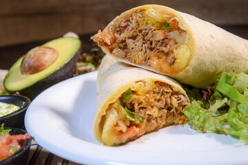 Burritos wraps with beef and vegetables on black background. Beef burrito, mexican food. Banner