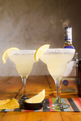 Frozen Margarita mixed drink with lime slice on plain background close up