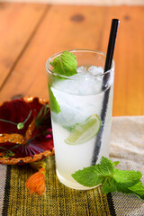 Frozen Margarita mixed drink with lime slice on plain background close up