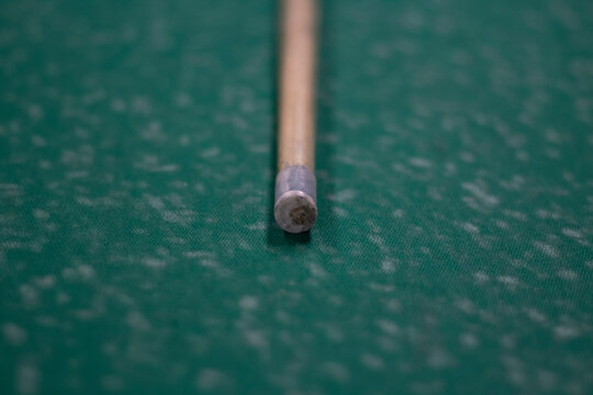 Billiard cue on the table. End of the billiard stick. 