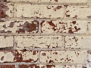 retro pealing paint at a close up view of old red brick wall part of an old warehouse building or alleyway and even the interior or exterior of building loft in rural or city environment