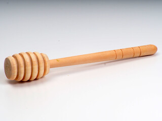 Picture of wooden honey dipper on a white isolated background