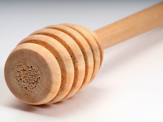 Fototapeta na wymiar Picture of wooden honey dipper on a white isolated background
