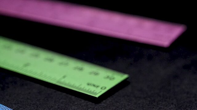 Colorful Metal Rulers on Black glass reflection