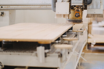 Closeup shot of an industrial plywood carving machine at work