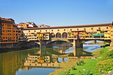 Fototapeta na wymiar Ponte Vecchio a medieval stone bridge in Florence. This is a landmark covered bridge with jewelry shops and spans the Arno river