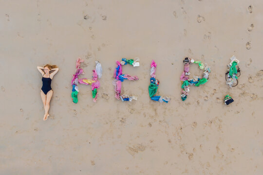 Help lettering made from trash on the beach